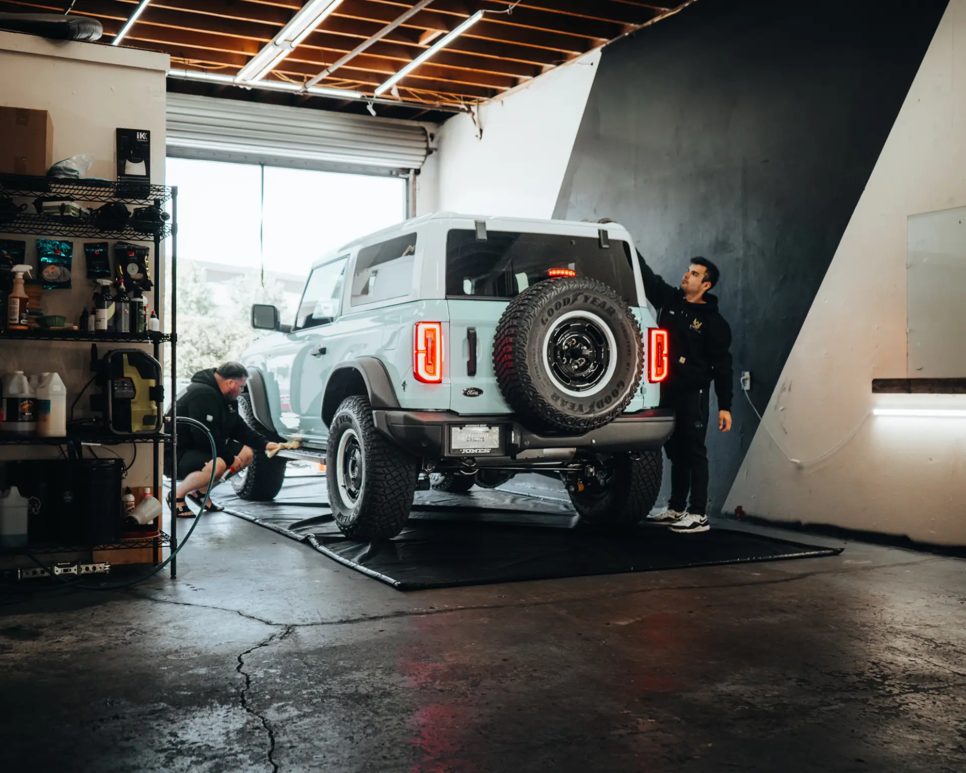 Kingdom Tint team working on a Ford Bronco inside the Carlsbad shop