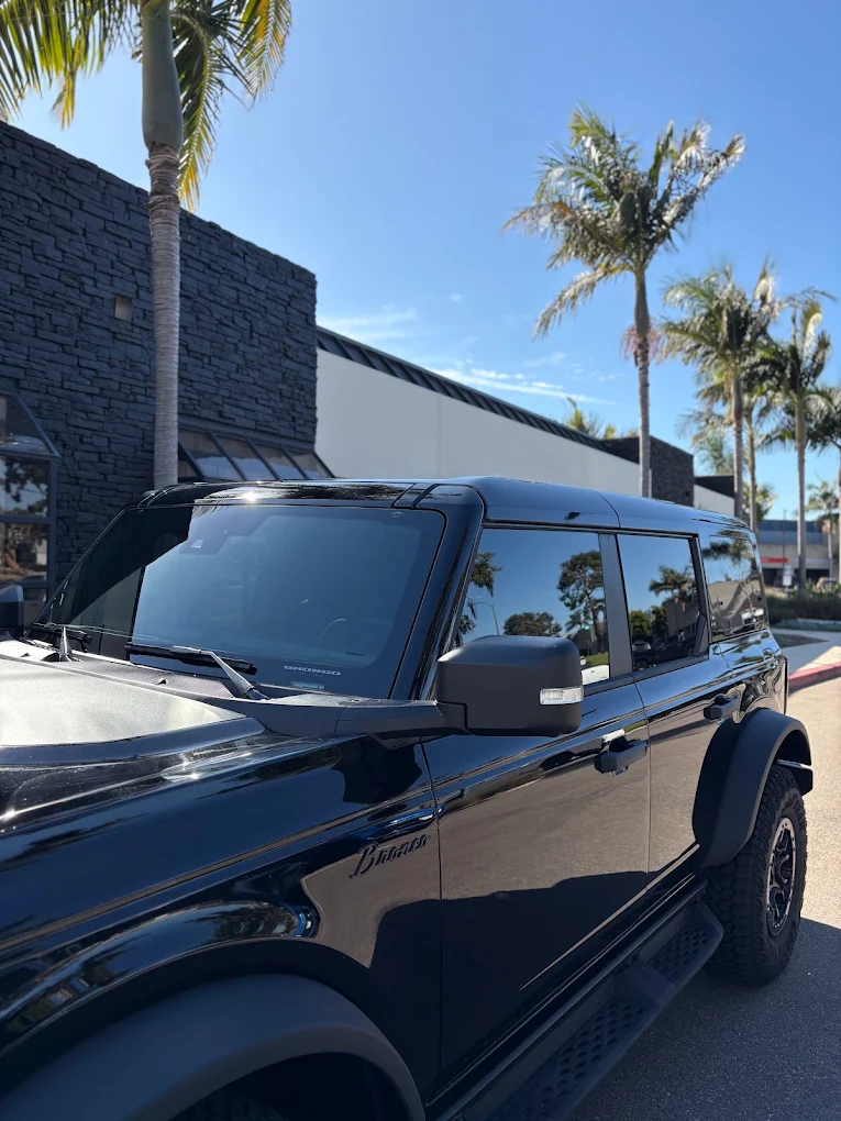 Black Ford Bronco with tinted windows outside the Kingdom Tint shop